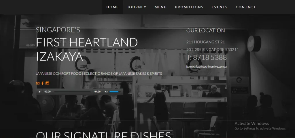 "Website homepage for Tachinomiya, featuring a black-and-white background of a busy Japanese bar. On-screen text reads 'Singapore's First Heartland Izakaya' along with location details for Hougang Street 21 and contact information."