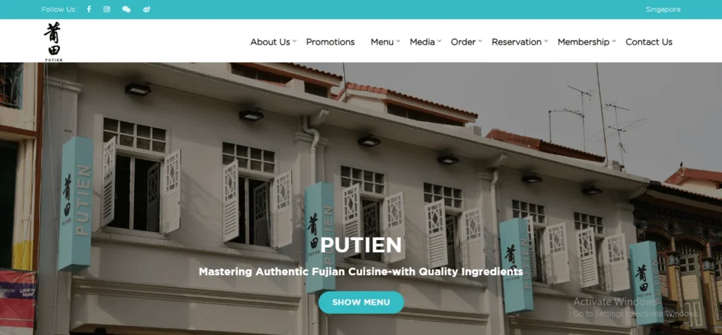 A screenshot of the PUTIEN restaurant website homepage, featuring a large banner image of a traditional shophouse building in Singapore with white shutters and light blue vertical signs. The overlay text reads "PUTIEN: Mastering Authentic Fujian Cuisine-with Quality Ingredients" above a teal "SHOW MENU" button. The top navigation bar includes links for About Us, Promotions, Menu, Media, Order, Reservation, Membership, and Contact Us.