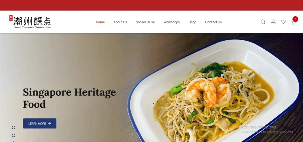 Screenshot of the website homepage for "Yoon’s Traditional Teochew Kueh," featuring a prominent banner with the heading "Singapore Heritage Food" and a dark blue "Learn More" button. The banner showcases a close-up image of a traditional dish of stir-fried Hokkien noodles with two large, peeled prawns, squid, and green vegetables, served in a classic blue-rimmed white enamel plate.