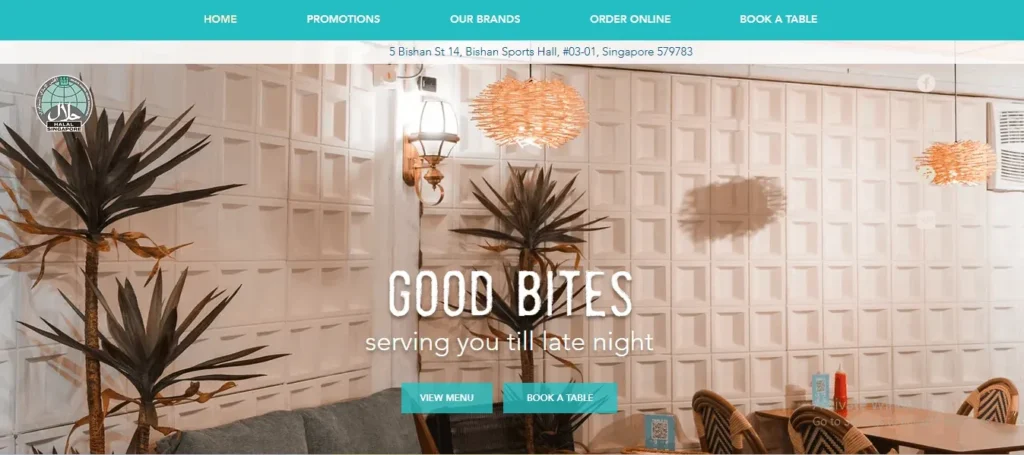 Website banner for "Good Bites" cafe at Bishan Sports Hall, Singapore, featuring their teal navigation menu, a Halal certification logo, and the tagline "serving you till late night" set against a warm interior cafe background.