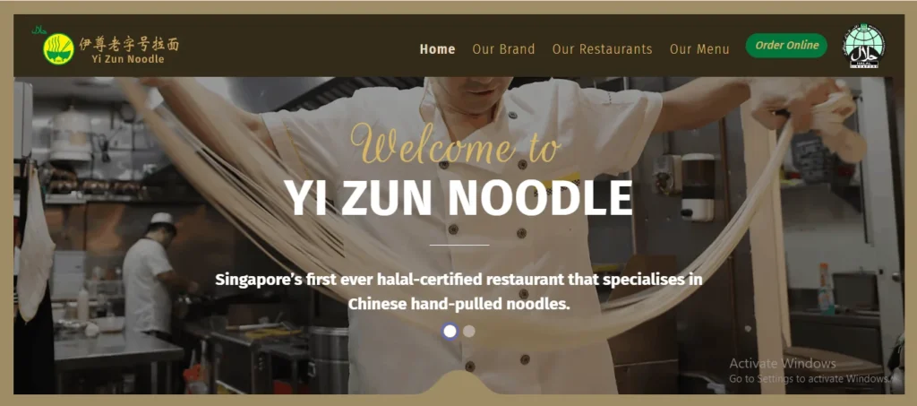 Website homepage banner for Yi Zun Noodle, showing a chef hand-pulling noodles in a commercial kitchen with text highlighting it as Singapore's first halal-certified restaurant specializing in Chinese hand-pulled noodles.