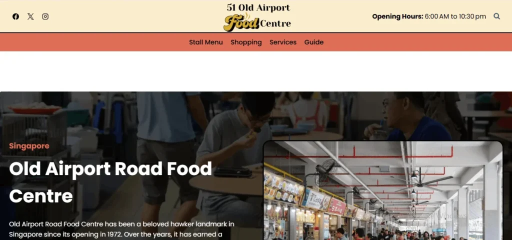 Screenshot of a website header for "51 Old Airport Food Centre" in Singapore. The top bar features social media icons, the food centre logo, and opening hours from 6:00 AM to 10:30 PM. Below a peach-colored navigation menu, a large banner displays a dimmed background photo of people dining, overlaid with the bold white text "Singapore / Old Airport Road Food Centre" and an introductory paragraph. An inset image on the bottom right shows an interior view of the bustling hawker centre stalls under a white ceiling with red piping and large fans.