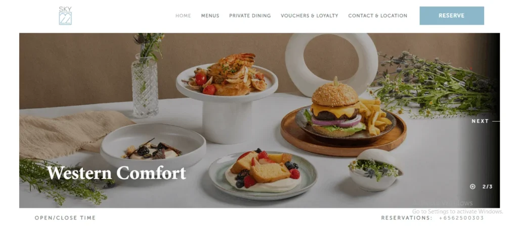 A screenshot of the Sky22 website homepage featuring a banner titled "Western Comfort" displaying a spread of dishes, including a gourmet burger with fries, seafood pasta on an elevated pedestal, a light dessert topped with fresh berries, and elegant table décor.