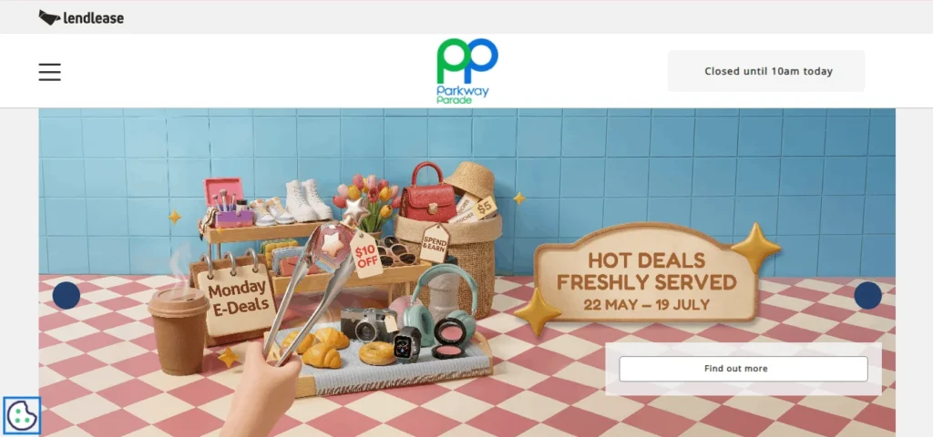 Website homepage for Parkway Parade shopping mall, managed by Lendlease, featuring a colorful promotional banner. The banner shows a stylized, miniature scene set against a blue tiled wall and a red-and-white checkered floor. A collection of retail items—including a camera, headphones, makeup, a handbag, shoes, croissants, and coffee—is displayed alongside a sign reading "Monday E-Deals." A large wooden sign on the right reads "HOT DEALS FRESHLY SERVED, 22 MAY – 19 JULY" with a "Find out more" button below it.