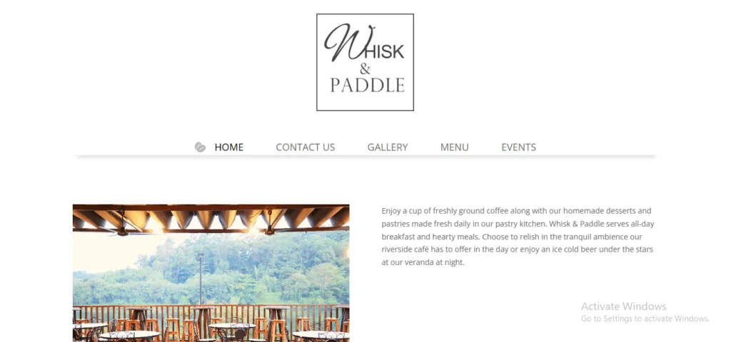 Outdoor veranda seating at Whisk & Paddle riverside cafe in Punggol.