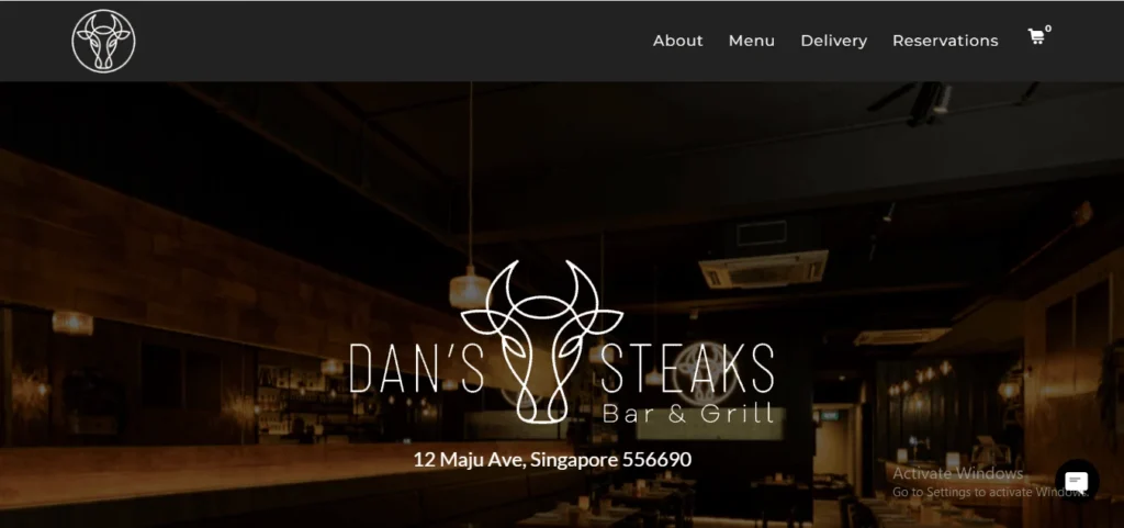 Screenshot of the website homepage for Dan's Steaks Bar & Grill, located at 12 Maju Ave, Singapore, featuring a dark interior background and a white bull logo.