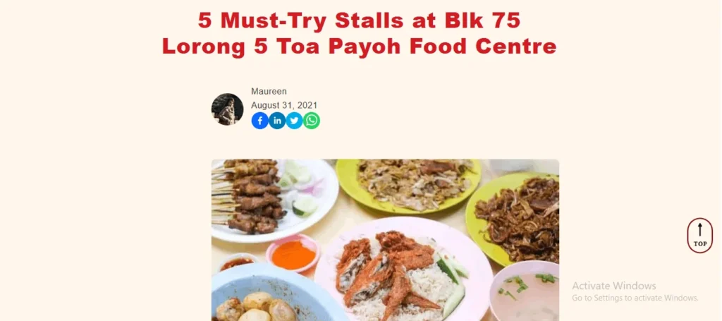 A screenshot of a food blog post titled "5 Must-Try Stalls at Blk 75 Lorong 5 Toa Payoh Food Centre" in large red text against a light cream background. Below the title, the author's name "Maureen" and the publication date "August 31, 2021" are displayed next to her profile picture and social media sharing icons (Facebook, LinkedIn, Twitter, and WhatsApp). The center of the page features a prominent food photograph showcasing a spread of various hawker dishes on colorful plates, including satay skewers, fried chicken wings with rice, fried noodles, and a bowl of soup. A small "TOP" arrow button is visible on the bottom right corner of the webpage.