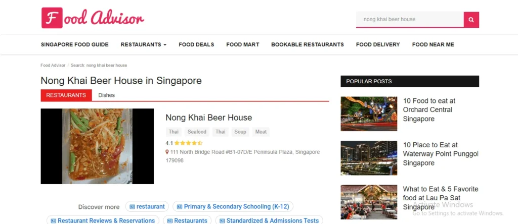 Screenshot of the Food Advisor website displaying search results for Nong Khai Beer House in Singapore, featuring a thumbnail of Som Tum green papaya salad, restaurant details, and popular blog posts in the sidebar.