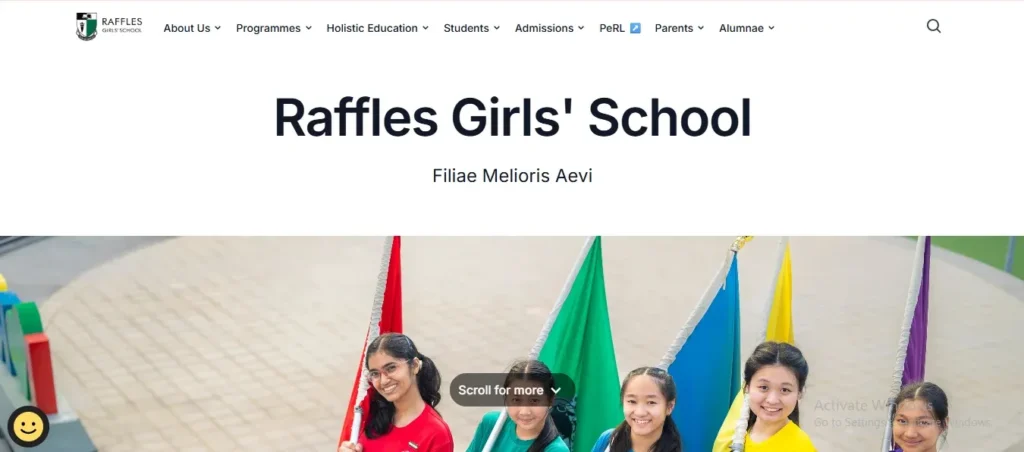 Homepage header for the Raffles Girls' School website featuring the school name, Latin motto "Filiae Melioris Aevi," top navigation bar, and a photo of five smiling female students holding up colorful house flags.