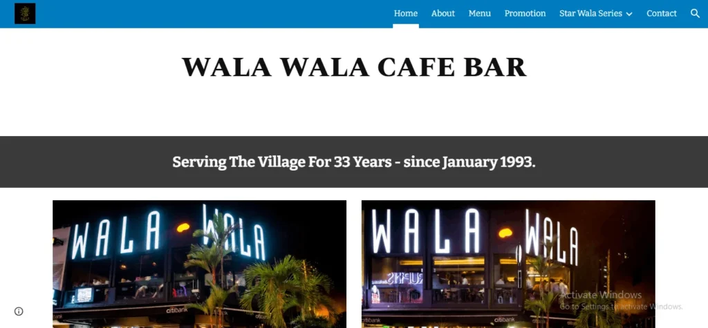 Website header for Wala Wala Cafe Bar featuring neon lit storefront signage and text stating "Serving The Village For 33 Years - since January 1993."