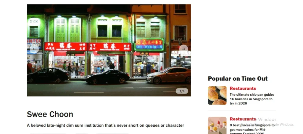 Exterior night view of the Swee Choon Tim Sum shopfront in Singapore, featuring vibrant red and green neon signage lit up across traditional shophouse storefronts with cars parked along the street.