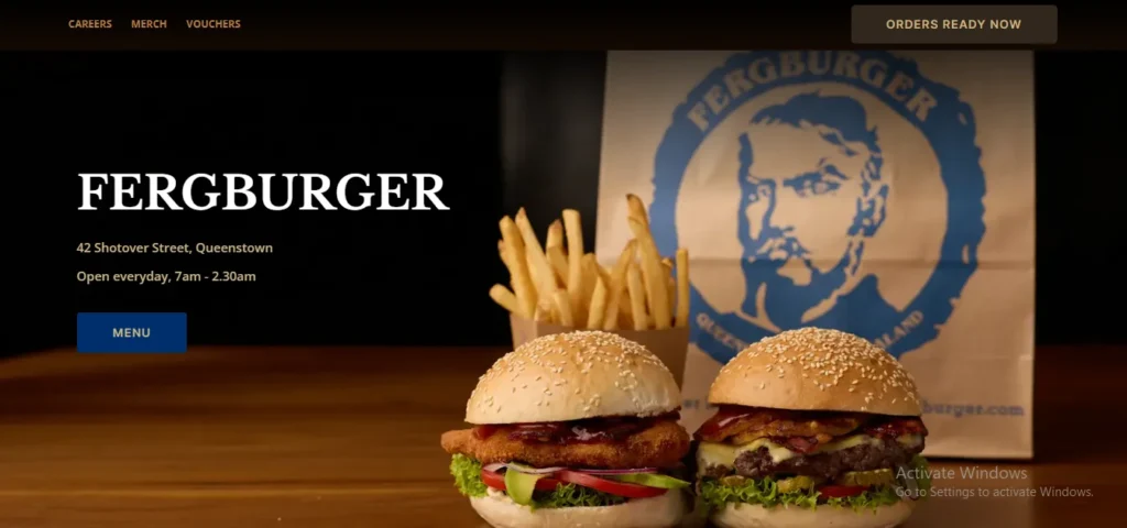 Two gourmet burgers on sesame seed buns served with french fries and a branded paper bag on the Fergburger website homepage.