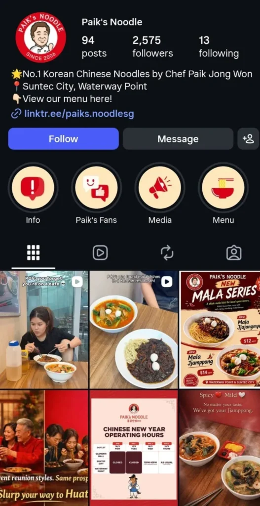 Screenshot of the Instagram profile for "Paik's Noodle," a Korean Chinese noodle restaurant by Chef Paik Jong Won. The header shows the logo featuring a cartoon illustration of Chef Paik, along with metrics listing 94 posts, 2,575 followers, and 13 following. The bio mentions locations at Suntec City and Waterway Point, accompanied by a Linktree menu link. Below the bio are story highlights titled "Info," "Paik's Fans," "Media," and "Menu." A six-post grid displays promotional content, including video clips of customers eating noodles, promotional flyers for a "New Mala Series" featuring Mala Jjajangmyeon and Mala Jjampong, Chinese New Year operating hours, and photos comparing spicy and mild noodle soups.
