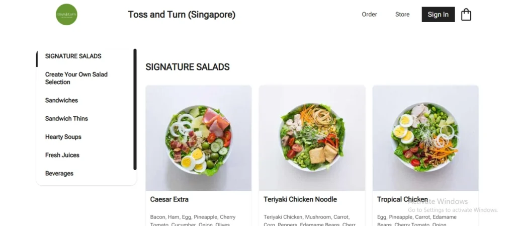 Website ordering page for Toss and Turn Singapore featuring signature salad bowls including Caesar Extra, Teriyaki Chicken Noodle, and Tropical Chicken.