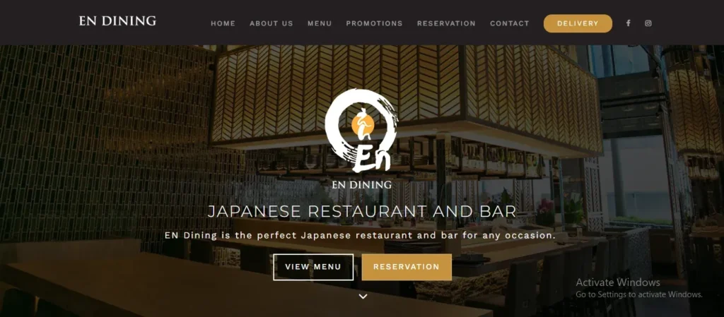 Screenshot of the EN Dining website header and hero banner. The dark top navigation bar includes the "EN DINING" logo on the left and menu options including "HOME," "ABOUT US," "MENU," "PROMOTIONS," "RESERVATION," "CONTACT," and a gold "DELIVERY" button on the right. Below the navigation, the background shows an interior view of a Japanese restaurant and bar with warm lighting and wooden finishes. Overlaying the center is the round brushstroke "En" logo, followed by the text "JAPANESE RESTAURANT AND BAR," a brief tag sentence, and two call-to-action buttons labeled "VIEW MENU" and "RESERVATION."