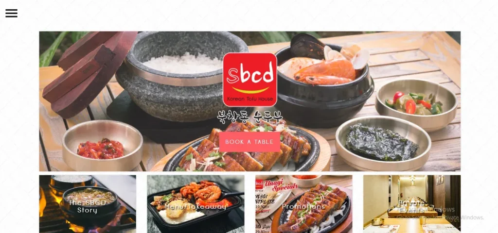 Website homepage for SBCD Korean Tofu House featuring a top banner with traditional Korean dishes like hot stone pot rice, seafood tofu stew, grilled eel, and side dishes, along with quick links to menu, promotions, and private events.