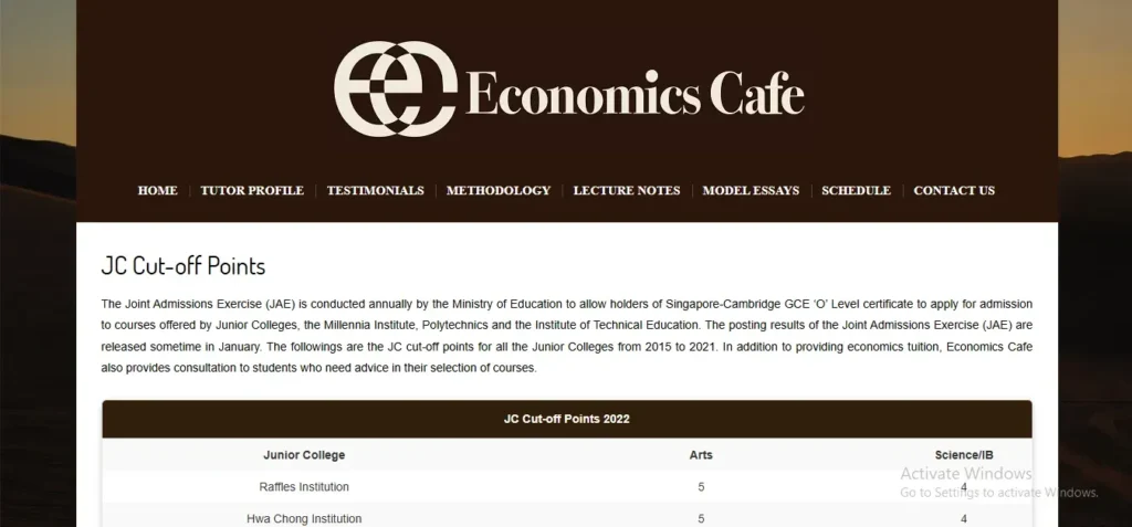 A screenshot of the Economics Cafe website page titled "JC Cut-off Points" with introductory text explaining the Joint Admissions Exercise (JAE). Below the text is a summary table titled "JC Cut-off Points 2022" listing Junior Colleges like Raffles Institution and Hwa Chong Institution alongside their respective entry cut-off points for Arts and Science/IB streams.