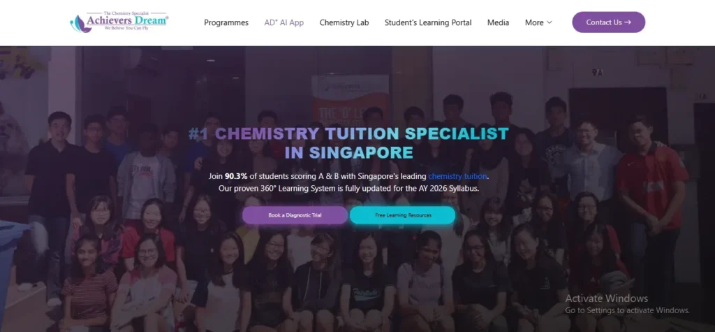 A website banner for Achievers Dream featuring a group photo of students against a dark background. Overlaying text highlights "#1 Chemistry Tuition Specialist in Singapore," noting that 90.3% of students score A and B, updated for the AY 2026 syllabus. Buttons prompt users to "Book a Diagnostic Trial" or access "Free Learning Resources."