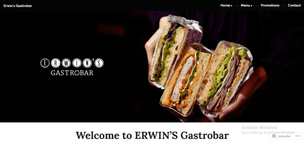 Website banner for Erwin's Gastrobar showing a person holding three gourmet sliced sandwiches wrapped in paper against a dark background, with the restaurant logo on the left.
