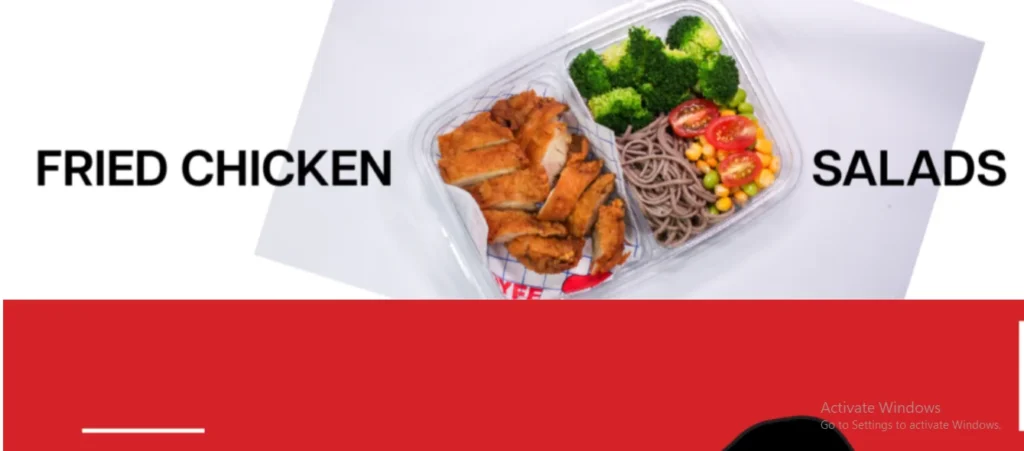 A meal prep container filled with sliced crispy fried chicken on one side, and soba noodles, steamed broccoli, corn, edamame, and cherry tomatoes on the other, flanked by the bold text "FRIED CHICKEN" on the left and "SALADS" on the right.